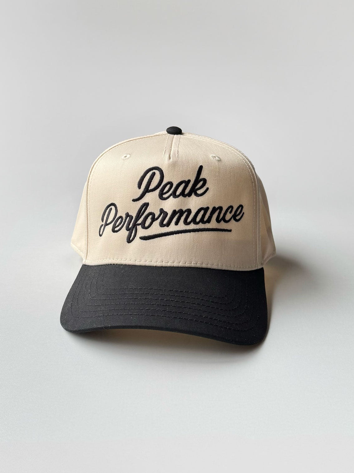 Peak Performance two-tone baseball hat in cream and black embroidery